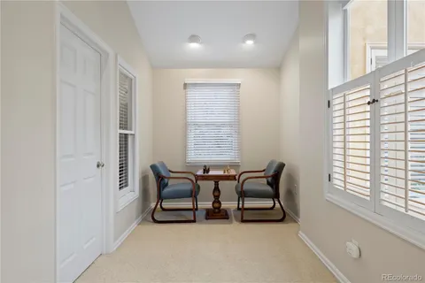 a spacious bathroom with a granite countertop sink a toilet and mirror