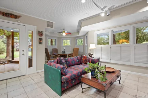 an aerial view of a house with balcony and trees al around