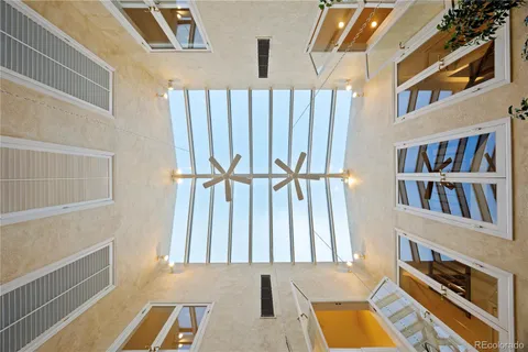 a living room with furniture a couch and a large window