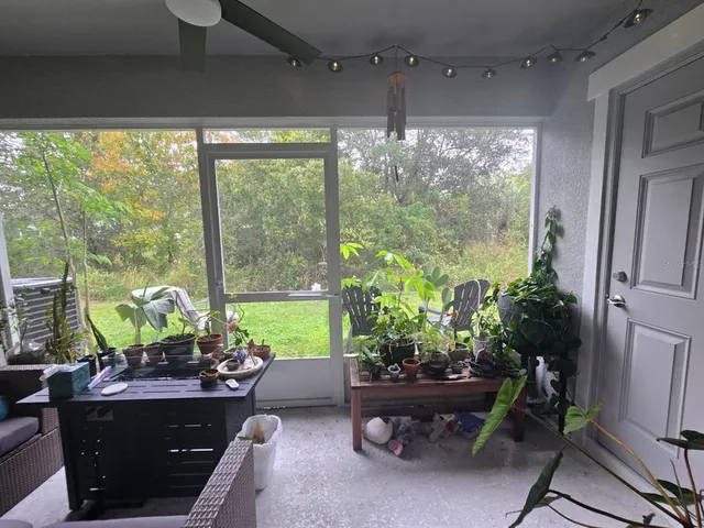a view of a house with backyard sitting area and furniture