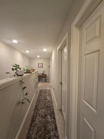 a bedroom with bed and a lamp on dresser