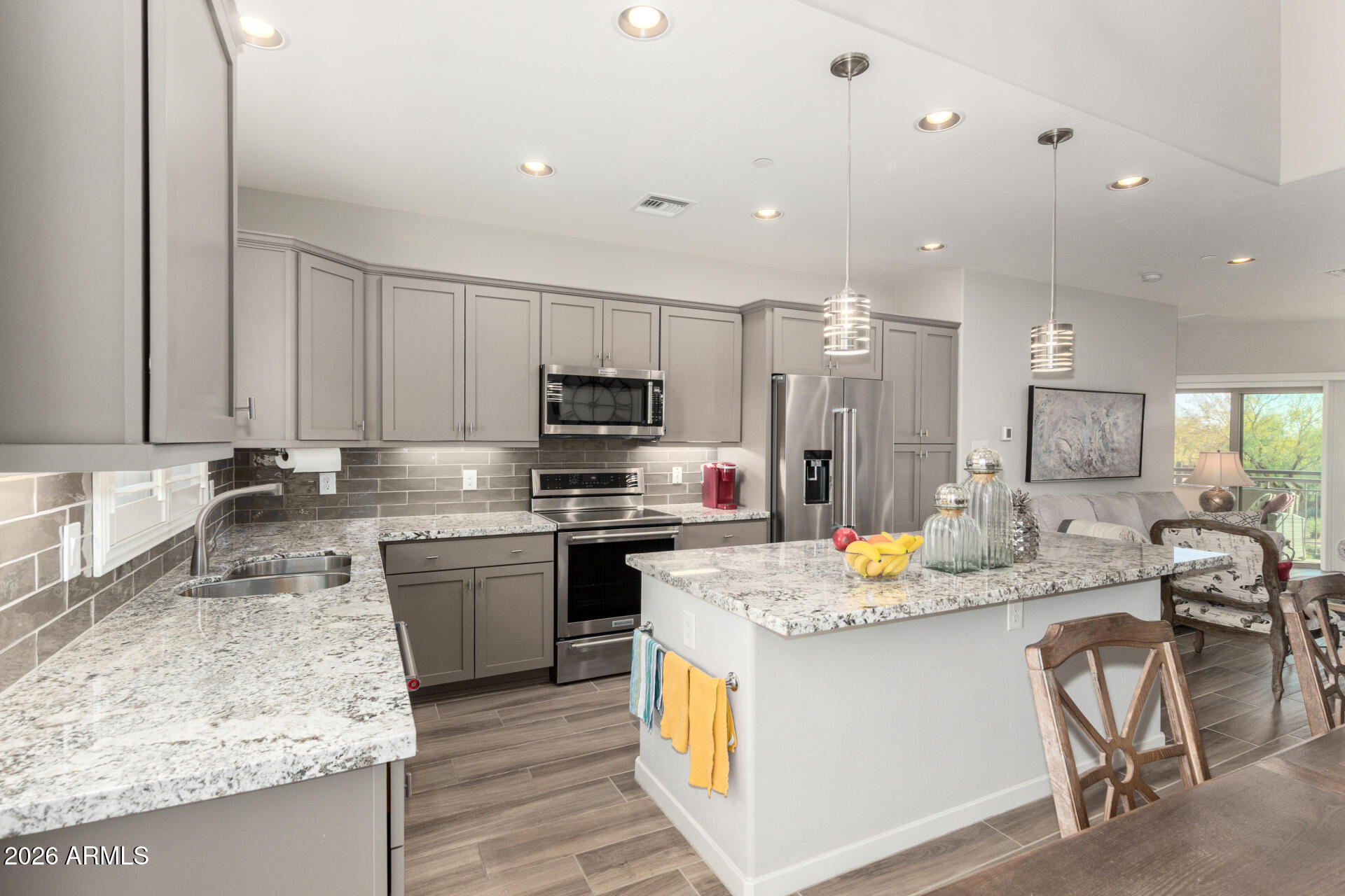 3935 East Rough Rider Road, Unit 1285 Phoenix, AZ 85050 - Photo 12 of 40 a kitchen with stainless steel appliances granite countertop a sink stove and refrigerator