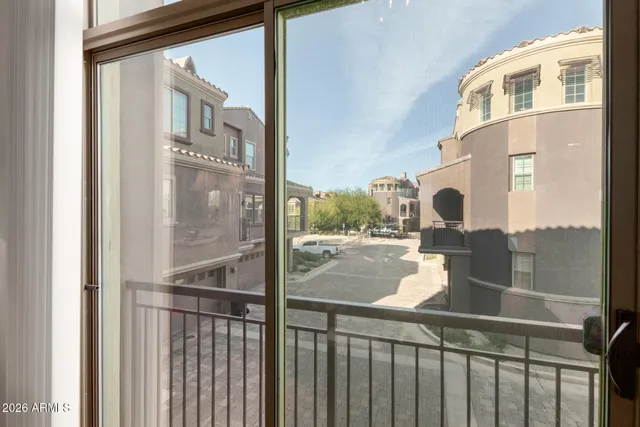 a view of a balcony with a glass door