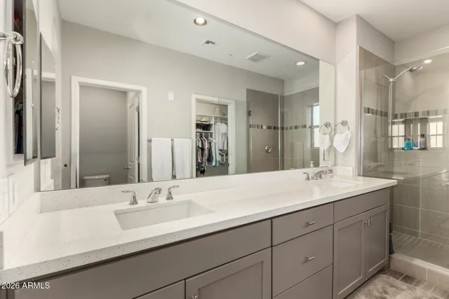 a bathroom with double vanity sinks and a mirror
