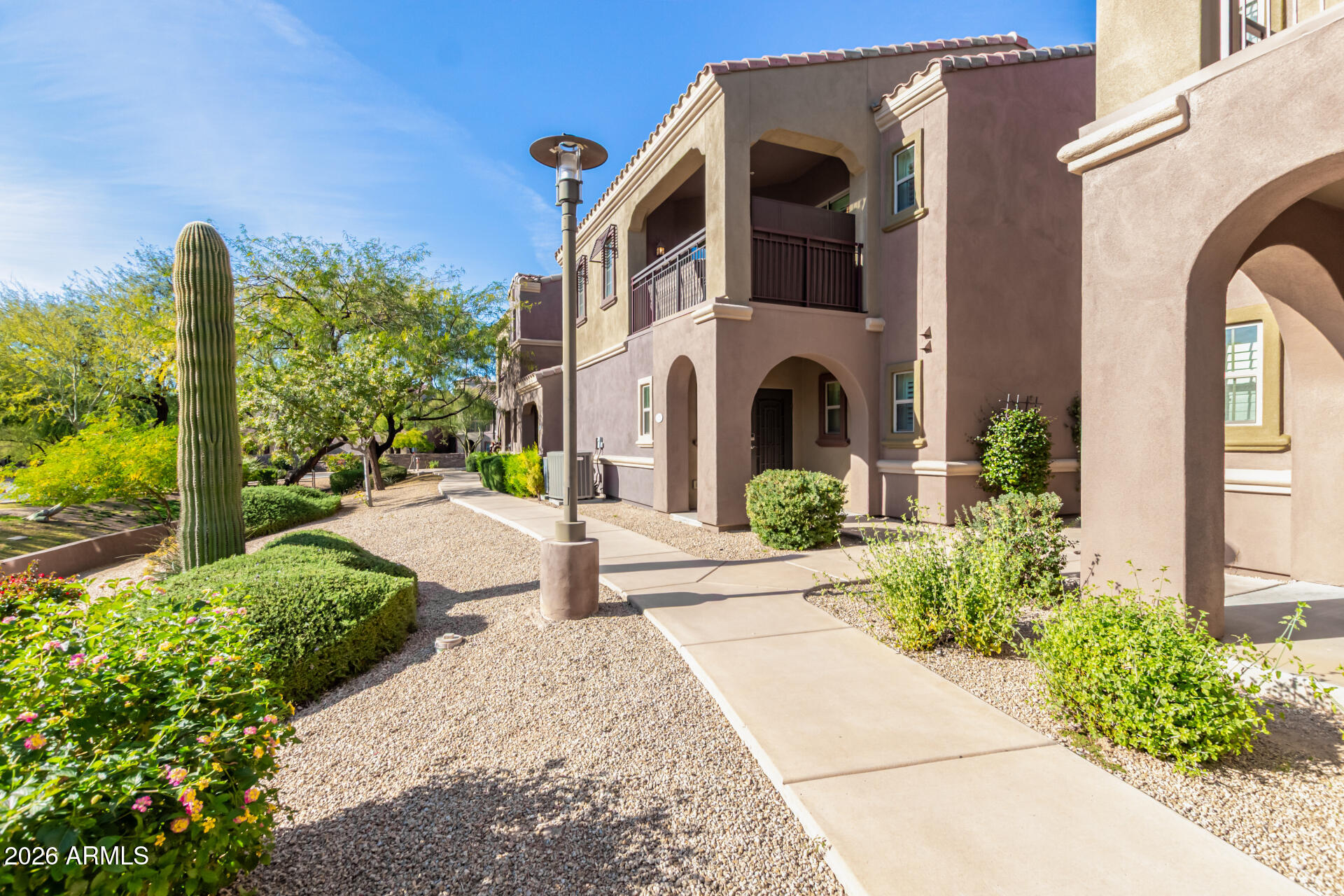 3935 East Rough Rider Road, Unit 1285 Phoenix, AZ 85050 - Photo 2 of 40 a front view of a house with garden