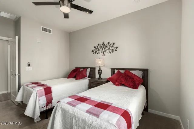 a bedroom with two beds and a night stand