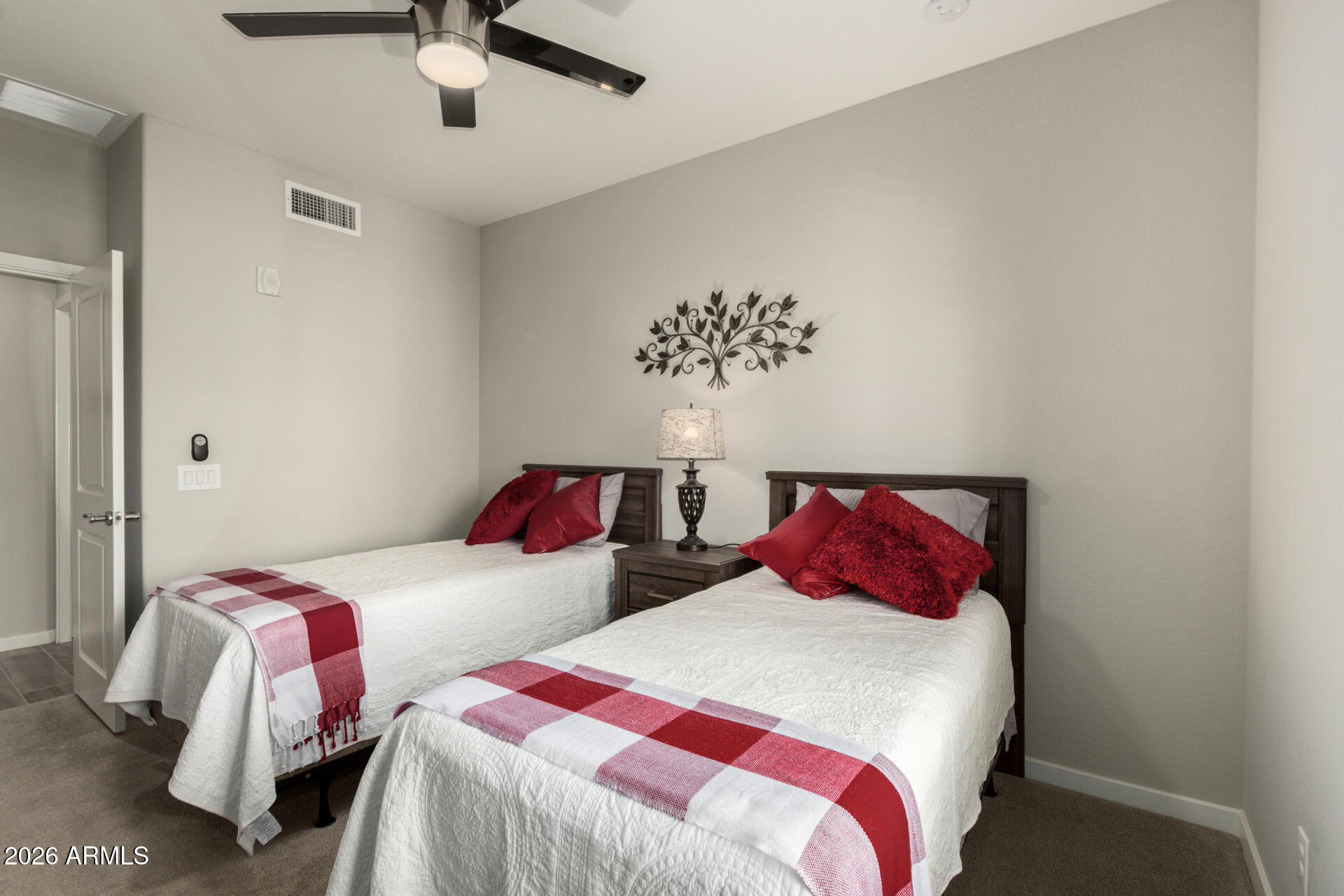 3935 East Rough Rider Road, Unit 1285 Phoenix, AZ 85050 - Photo 21 of 40 a bedroom with two beds and a night stand