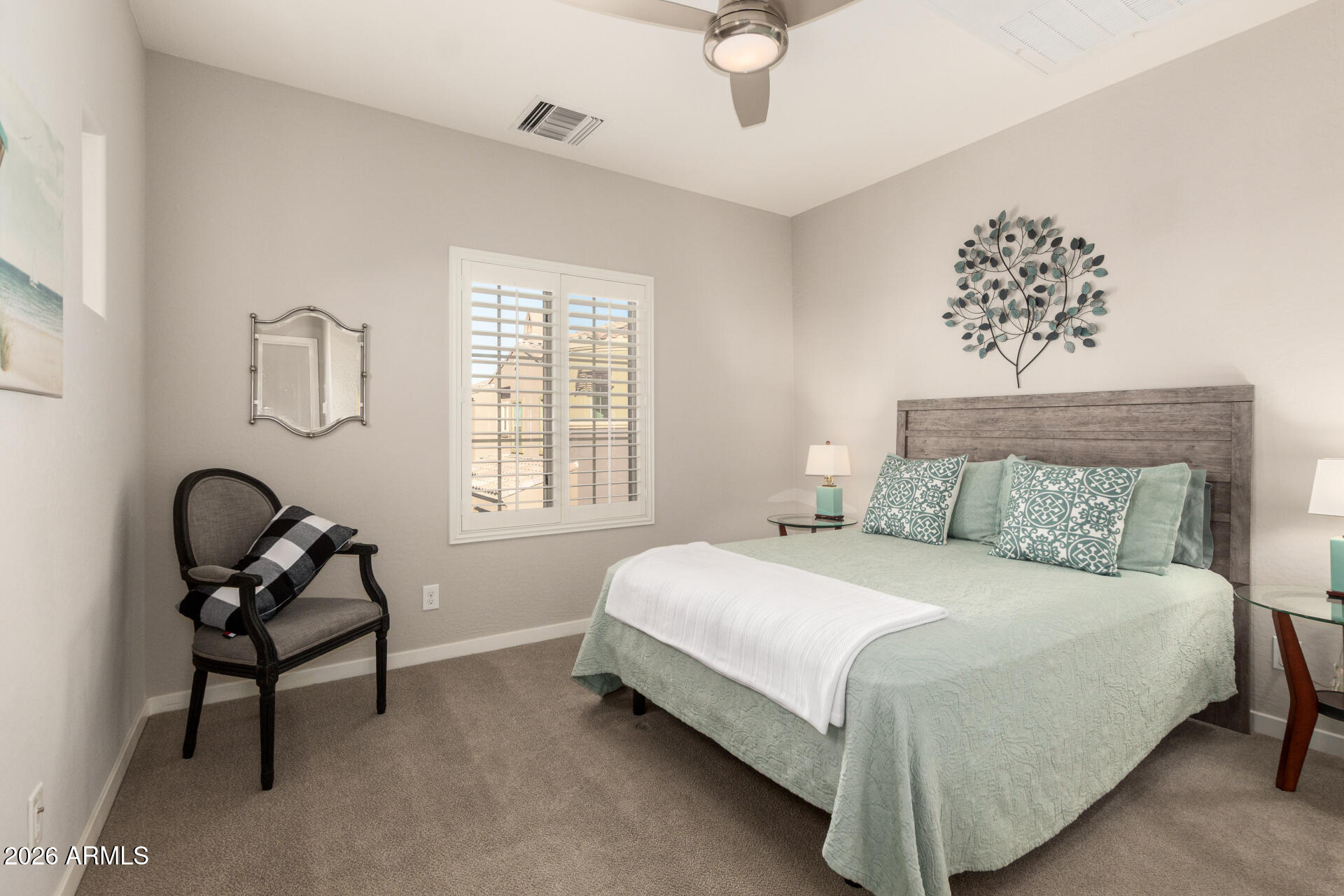 3935 East Rough Rider Road, Unit 1285 Phoenix, AZ 85050 - Photo 24 of 40 a bedroom with a bed and a chandelier