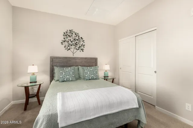 a bedroom with a bed and a chandelier