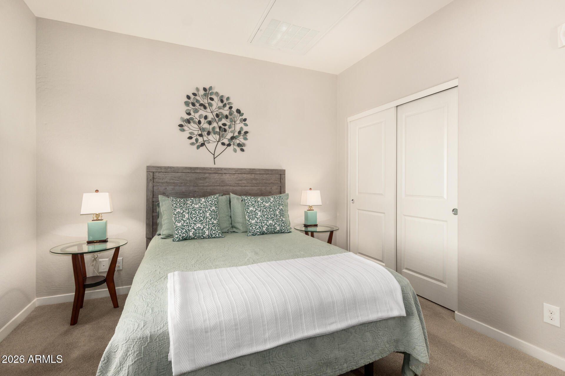 3935 East Rough Rider Road, Unit 1285 Phoenix, AZ 85050 - Photo 25 of 40 a bedroom with a bed and a chandelier