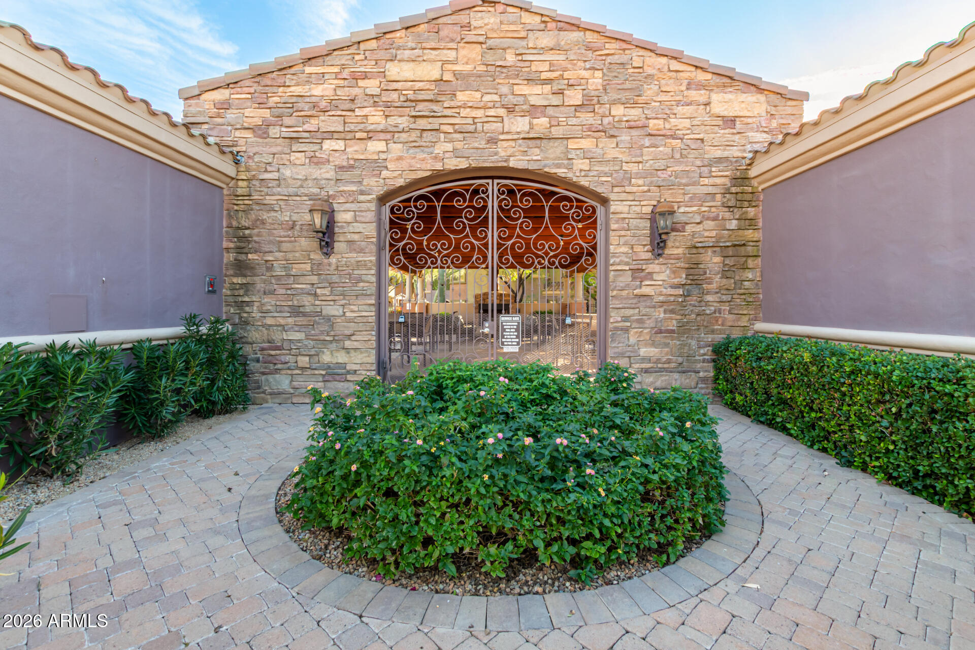 3935 East Rough Rider Road, Unit 1285 Phoenix, AZ 85050 - Photo 34 of 40 a view of entrance gate with a garden