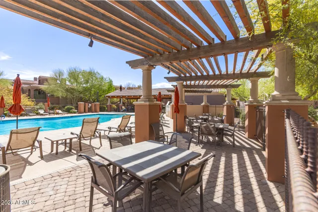 a view of a chairs and table in patio