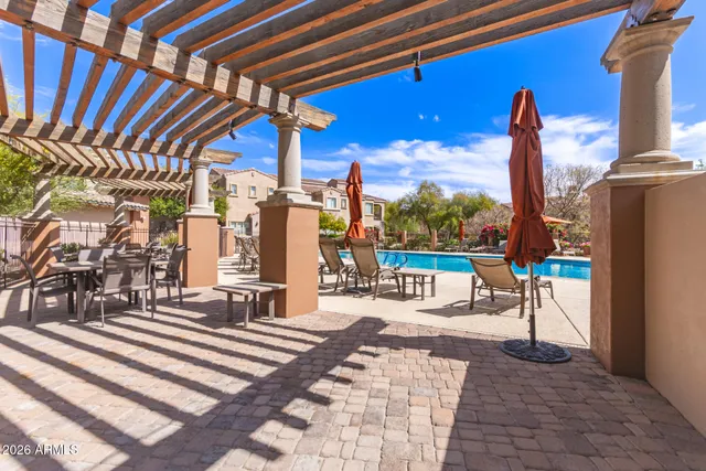 a view of a patio with a table and chairs