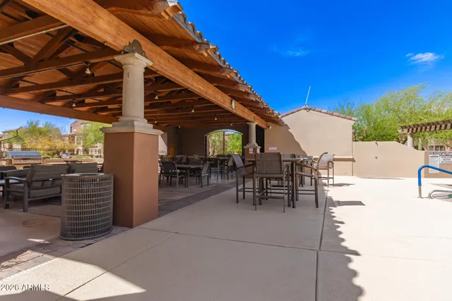 a view of a patio with table and chairs with wooden floor and fence