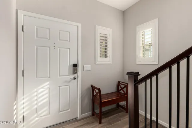 a view of entryway with wooden floor and stairs