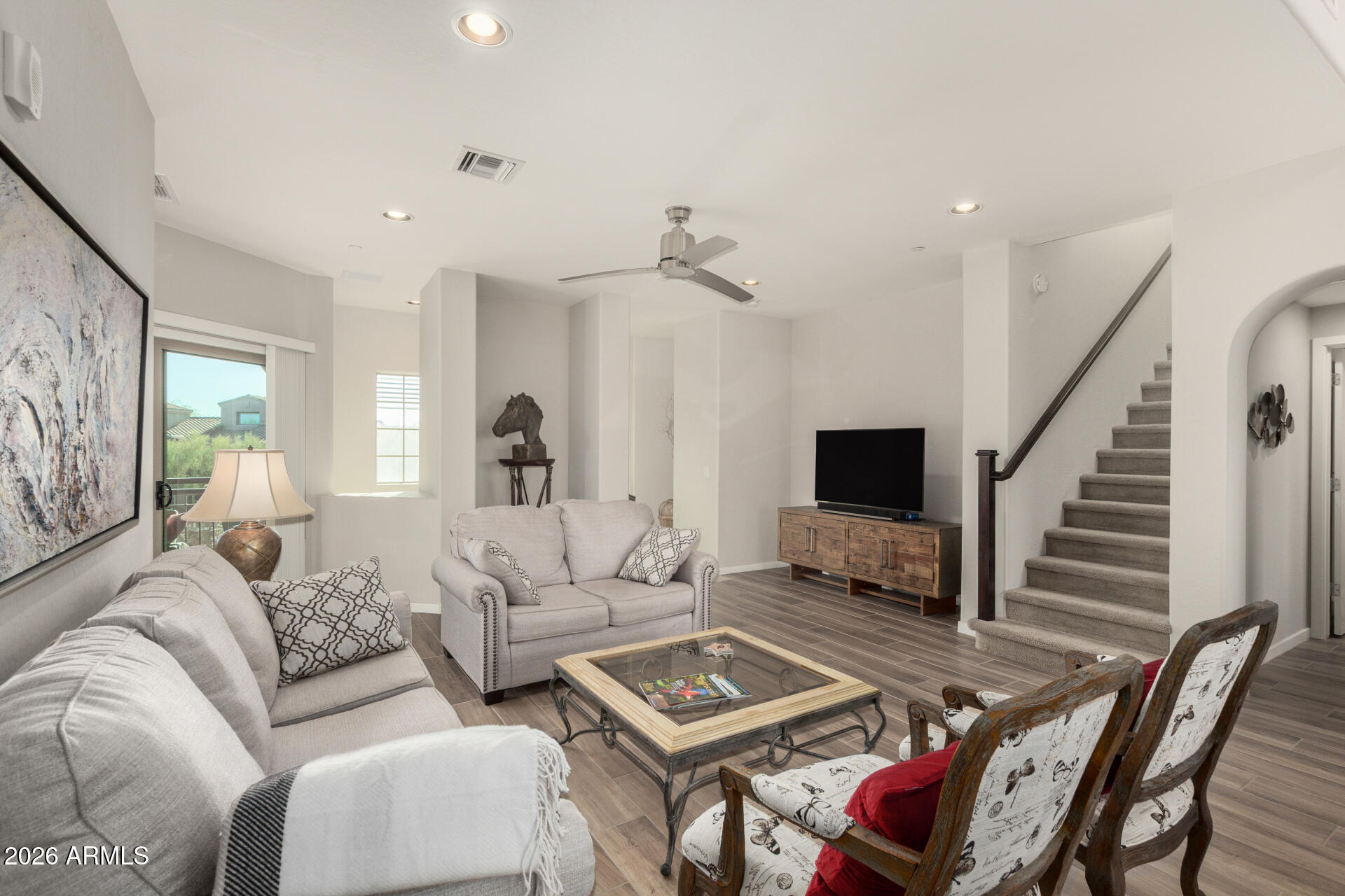 3935 East Rough Rider Road, Unit 1285 Phoenix, AZ 85050 - Photo 7 of 40 a living room with furniture a flat screen tv and a table