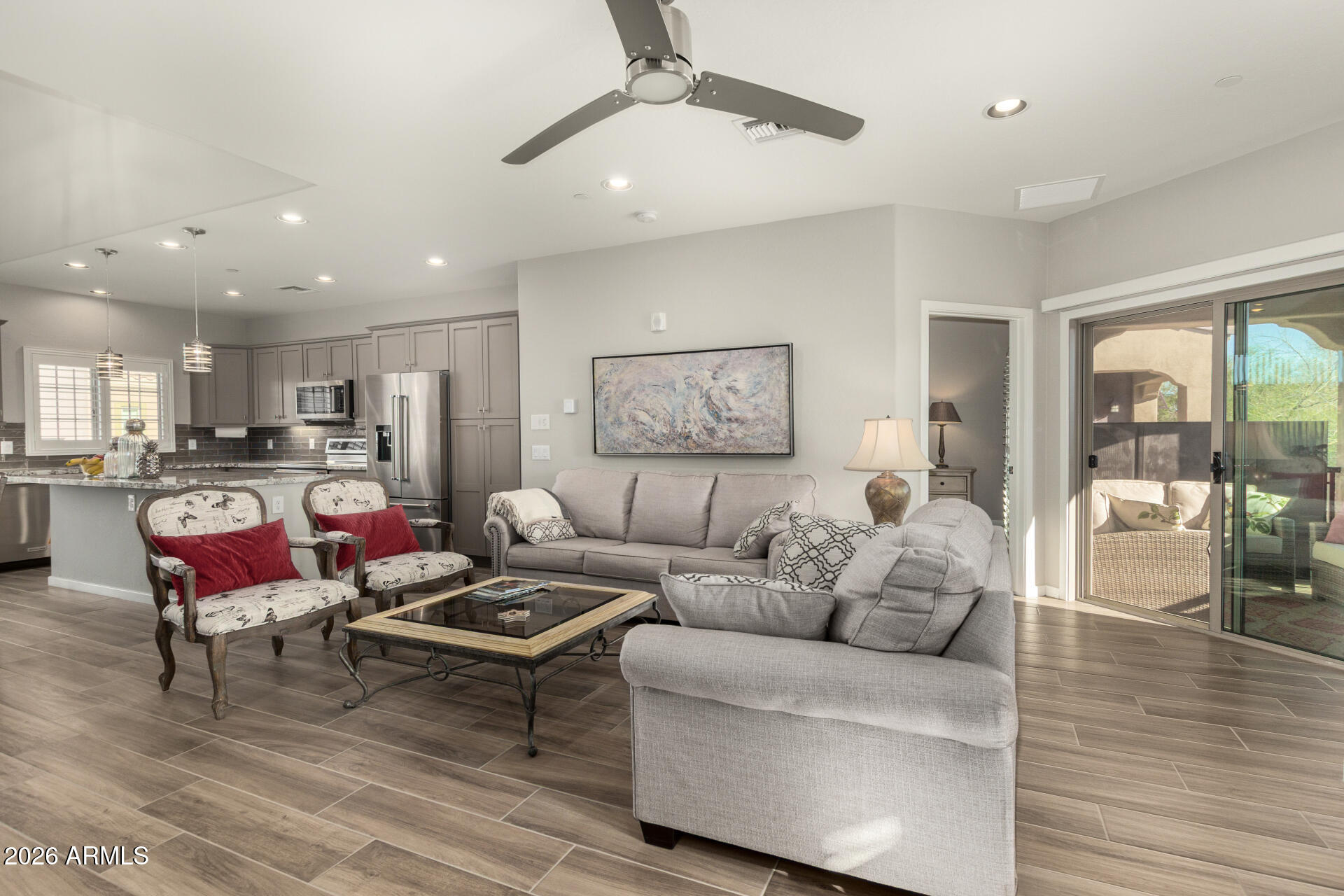 3935 East Rough Rider Road, Unit 1285 Phoenix, AZ 85050 - Photo 8 of 40 a living room with furniture kitchen view and a wooden floor