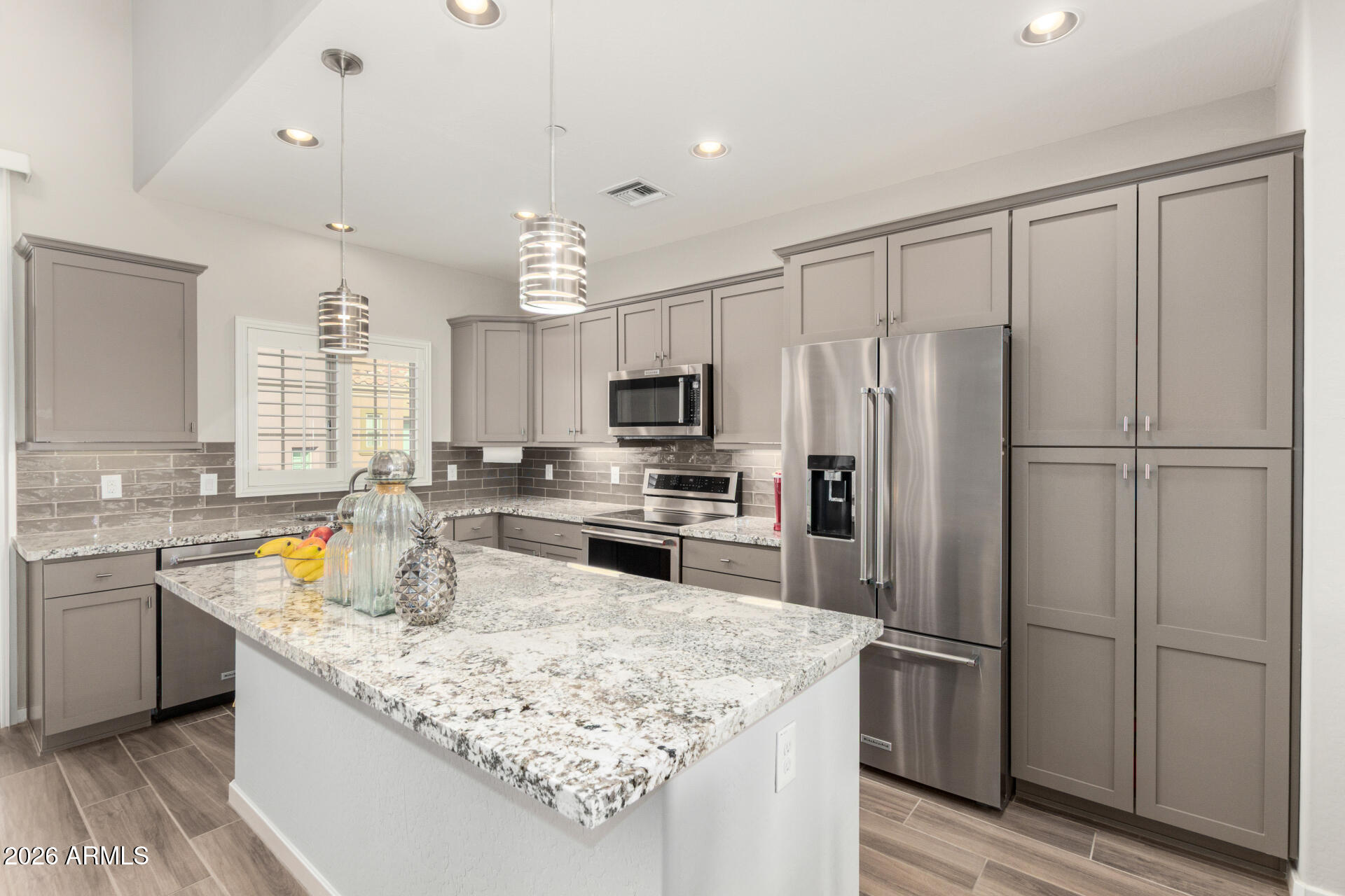 3935 East Rough Rider Road, Unit 1285 Phoenix, AZ 85050 - Photo 10 of 40 a kitchen with a refrigerator a sink and cabinets