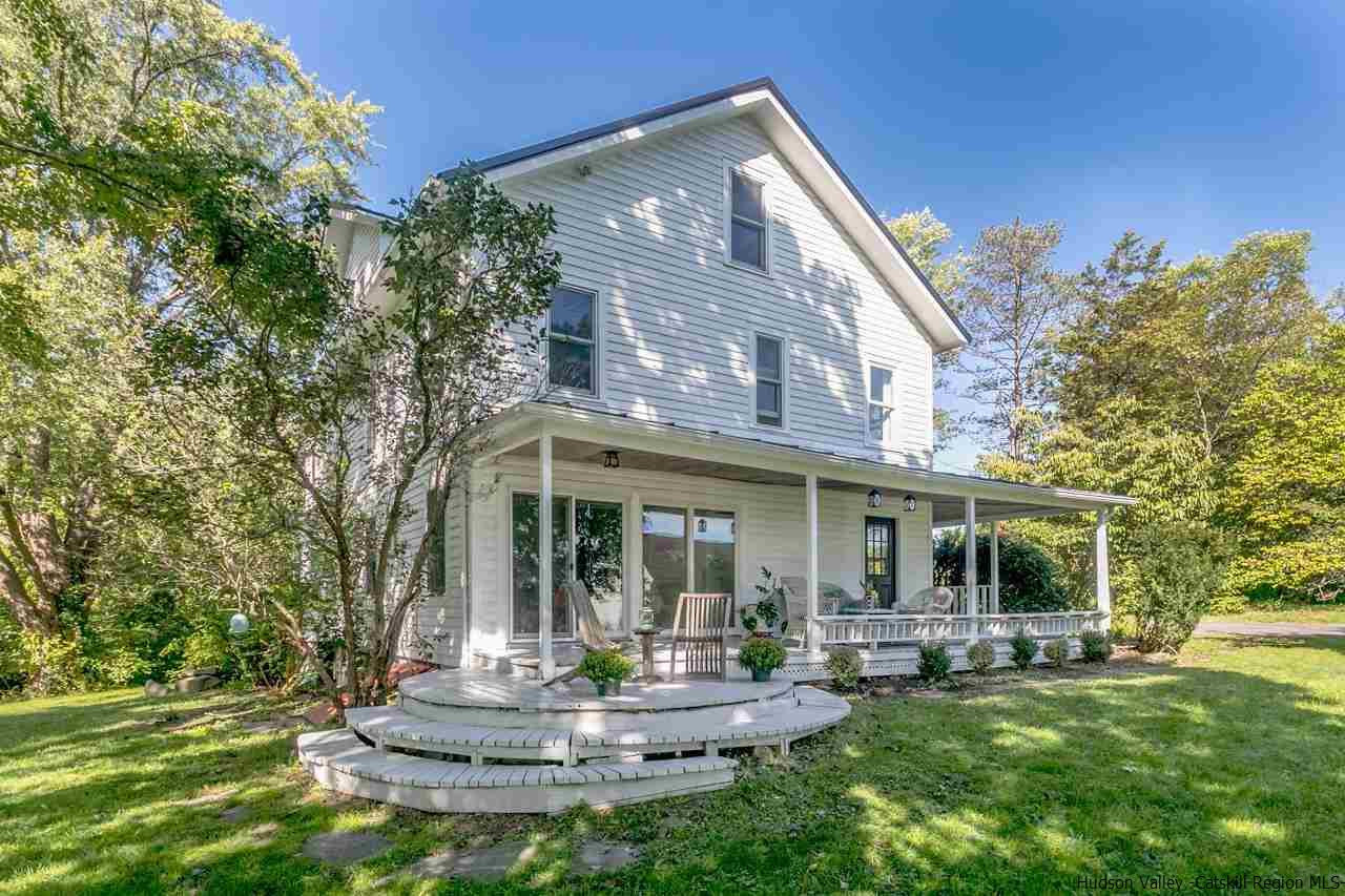 a view of a house with backyard porch and sitting area