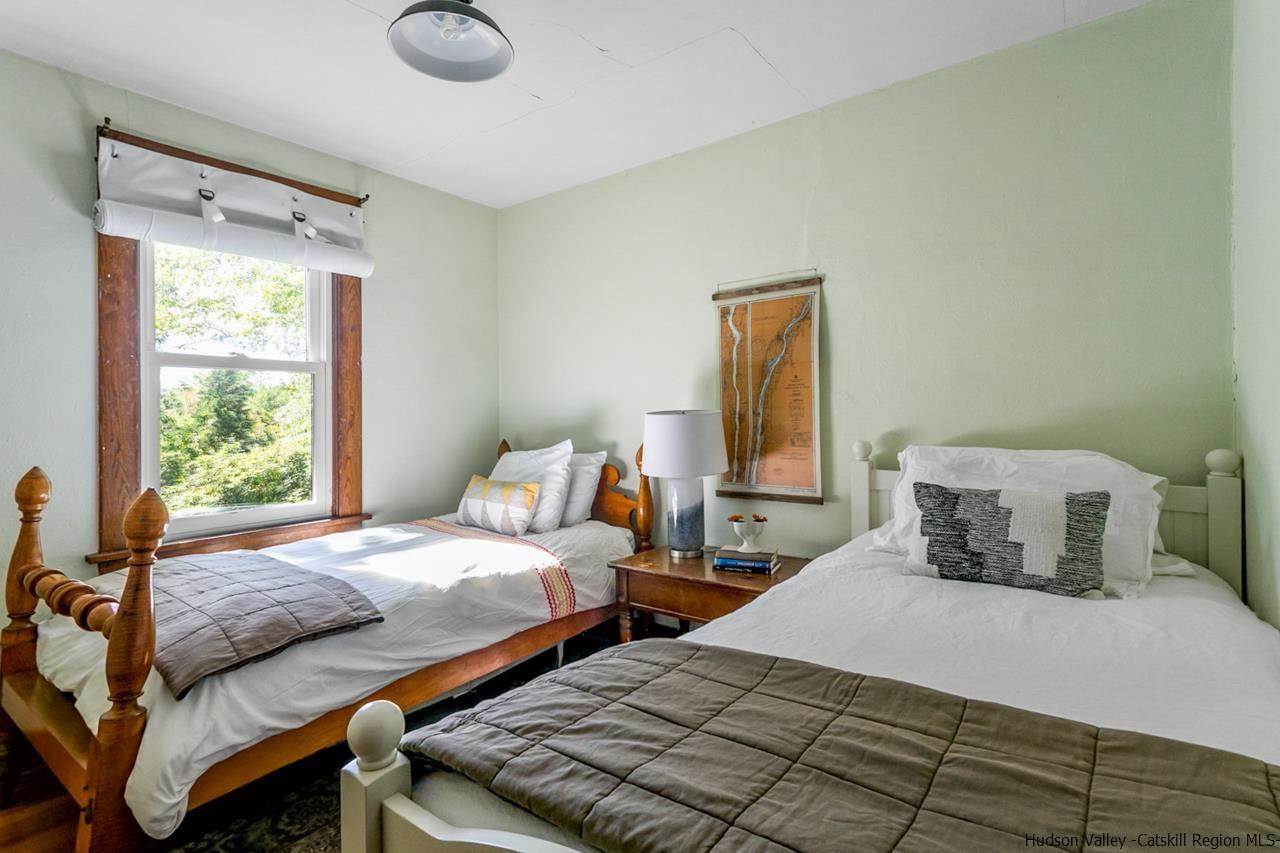 807 Leeds Athens Road Athens, NY 12015 - Photo 17 of 29 a bedroom with two beds and a window