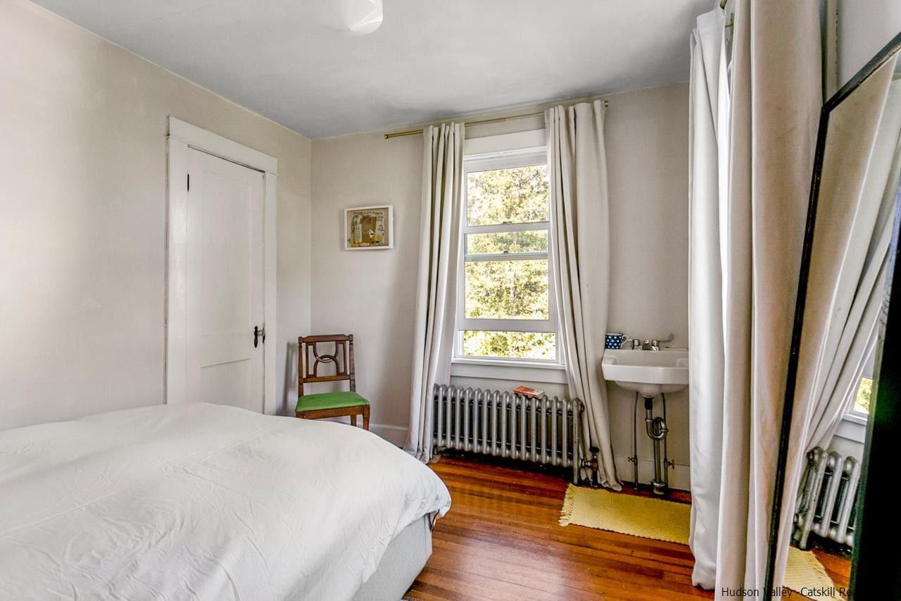 807 Leeds Athens Road Athens, NY 12015 - Photo 19 of 29 a bedroom with a bed and a window