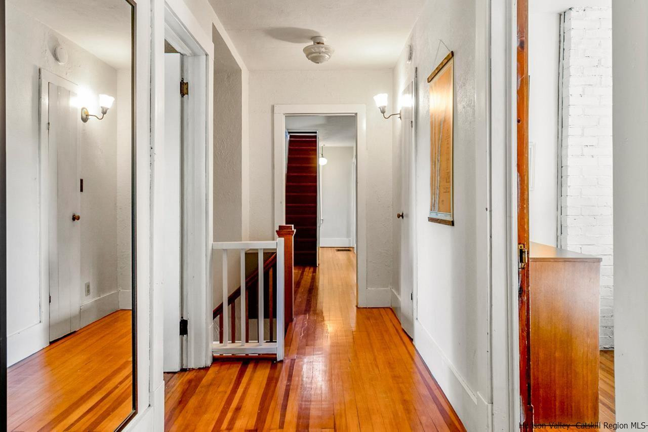 807 Leeds Athens Road Athens, NY 12015 - Photo 23 of 29 a view of a hallway with wooden floor and staircase