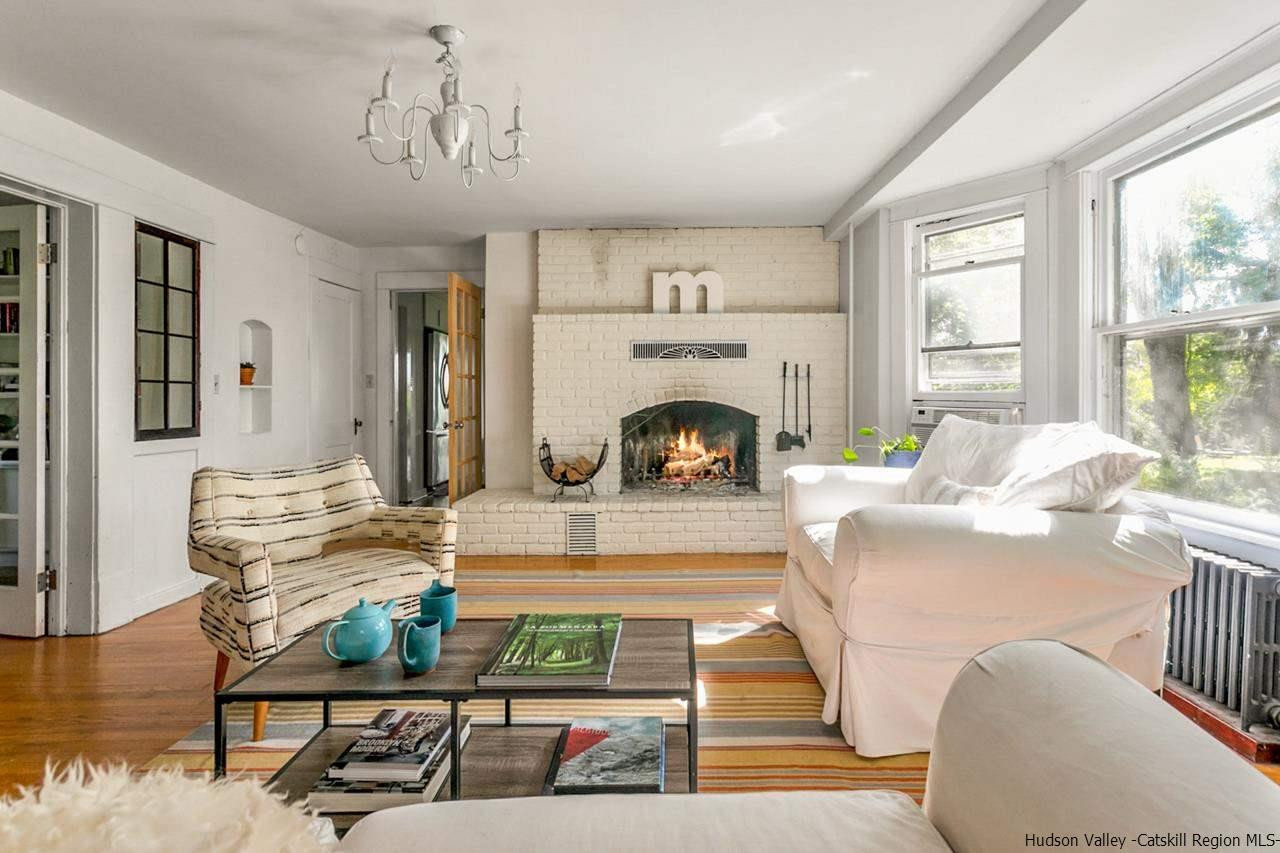 807 Leeds Athens Road Athens, NY 12015 - Photo 3 of 29 a living room with furniture a fireplace and a table