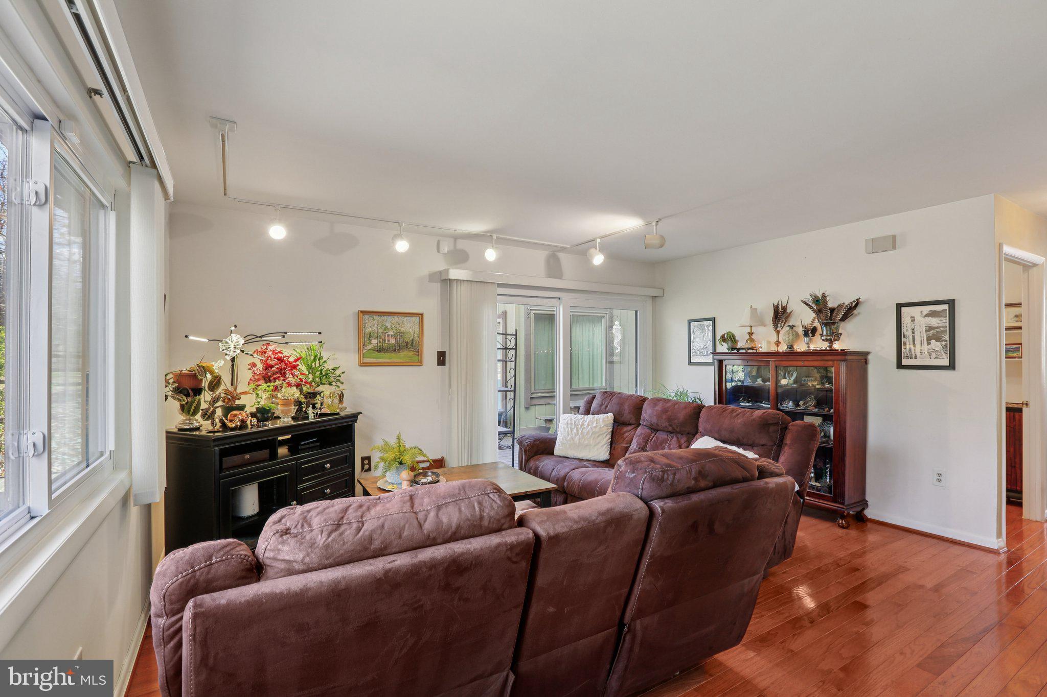 10968 Swansfield Road Columbia, MD 21044 - Photo 11 of 57 a living room with furniture and a chandelier