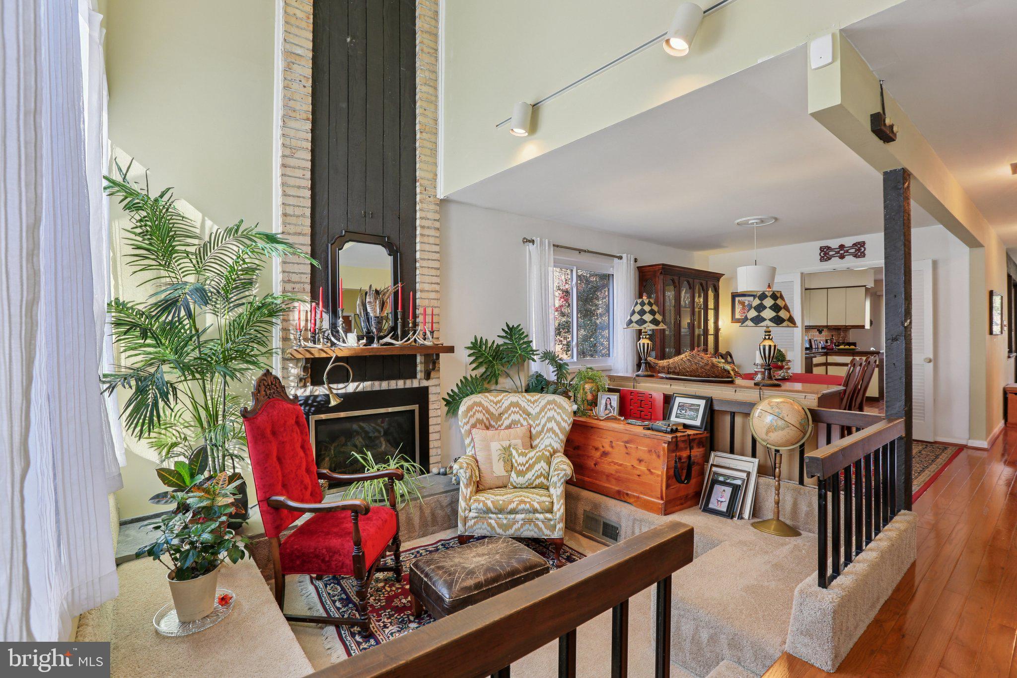 10968 Swansfield Road Columbia, MD 21044 - Photo 13 of 57 a living room with furniture fireplace and potted plant