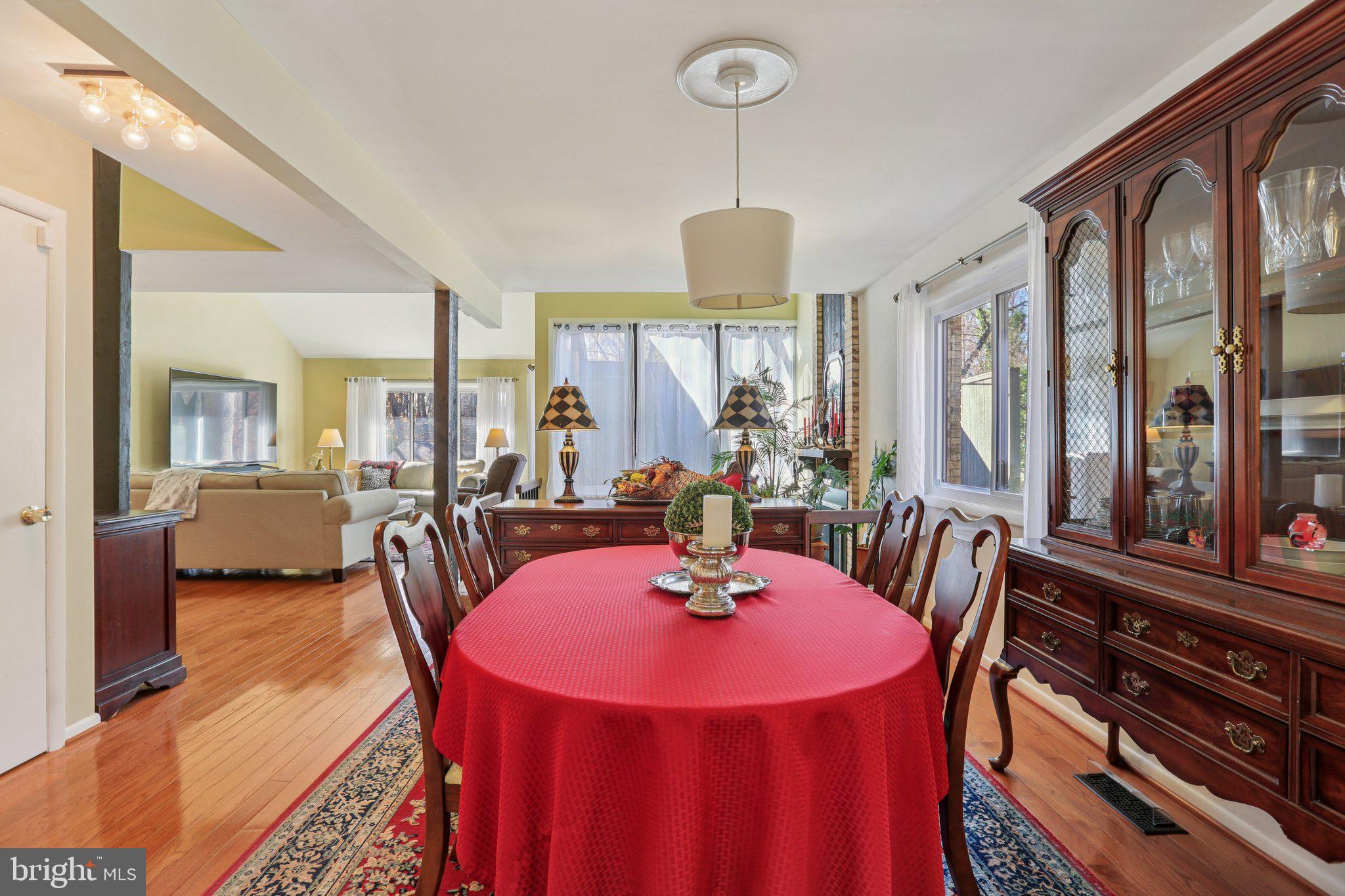 10968 Swansfield Road Columbia, MD 21044 - Photo 16 of 57 a view of a dining room with furniture window and wooden floor