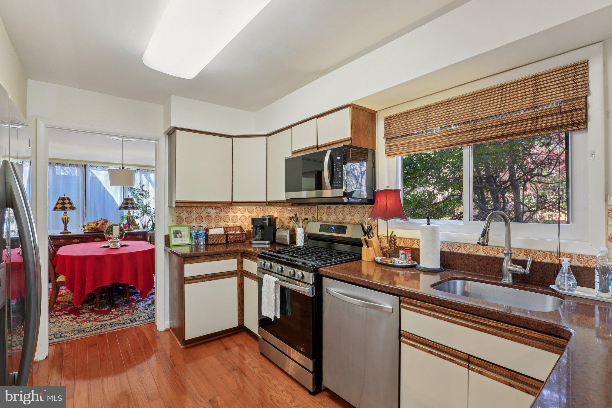 10968 Swansfield Road Columbia, MD 21044 - Photo 21 of 57 a kitchen with a stove a sink and a microwave