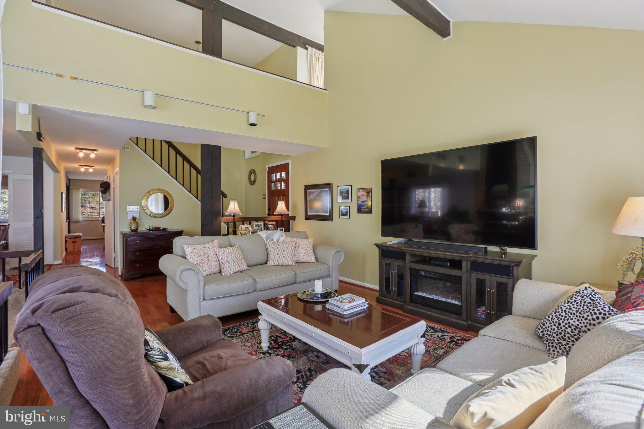 10968 Swansfield Road Columbia, MD 21044 - Photo 10 of 57 a living room with furniture and a flat screen tv