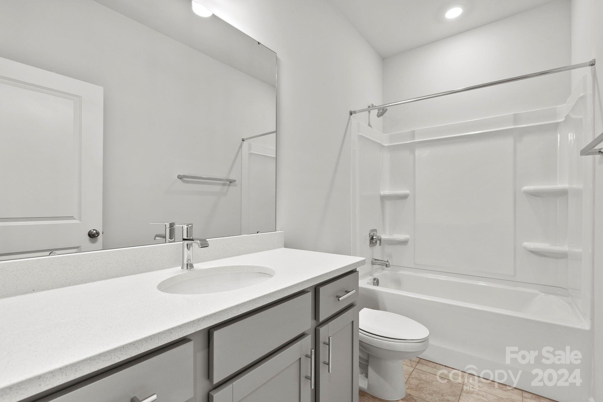 1702 Blanche Street Albemarle, NC 28001 - Photo 16 of 29 a bathroom with a sink a toilet and a bathtub
