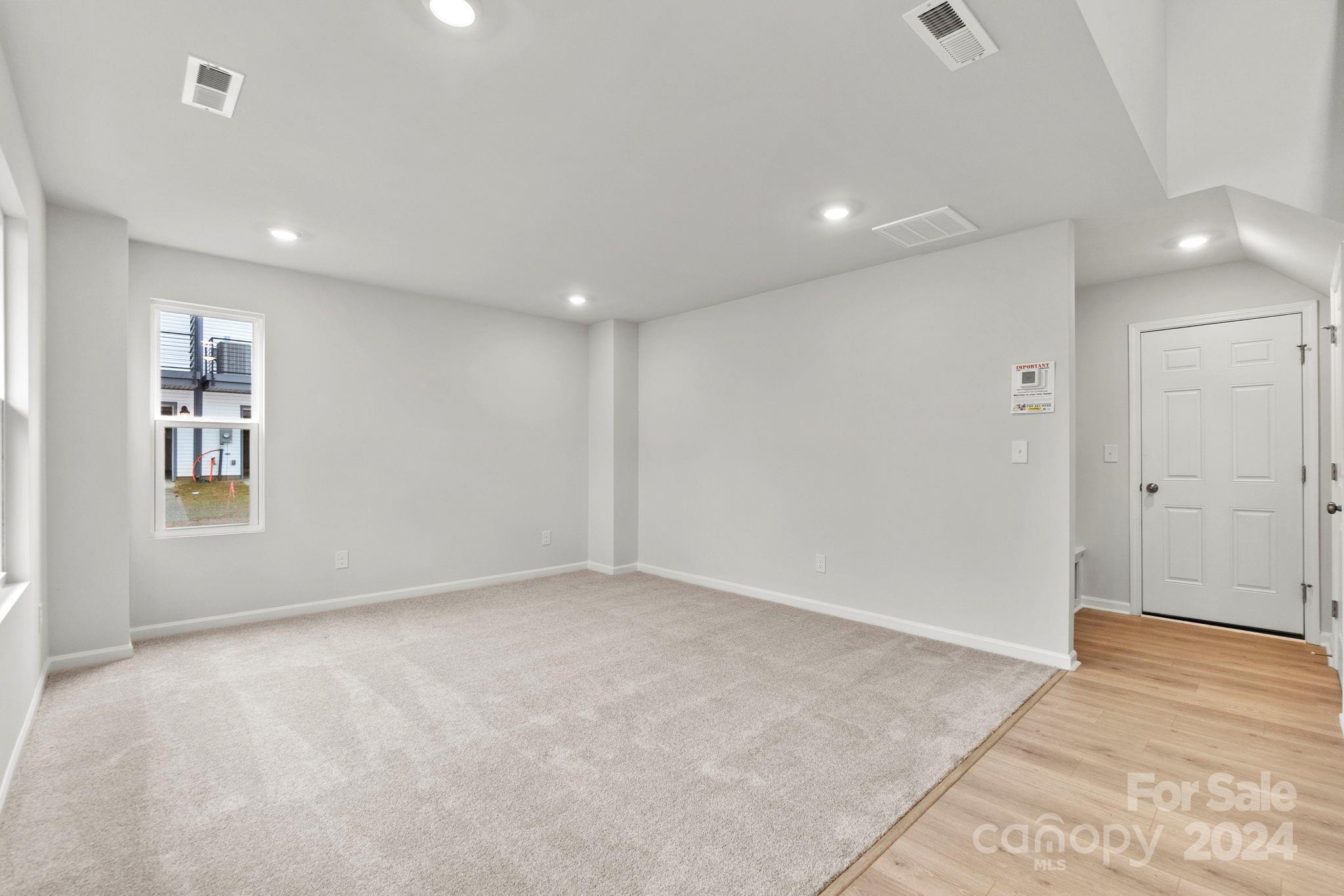 1702 Blanche Street Albemarle, NC 28001 - Photo 19 of 29 an empty room with wooden floor and windows