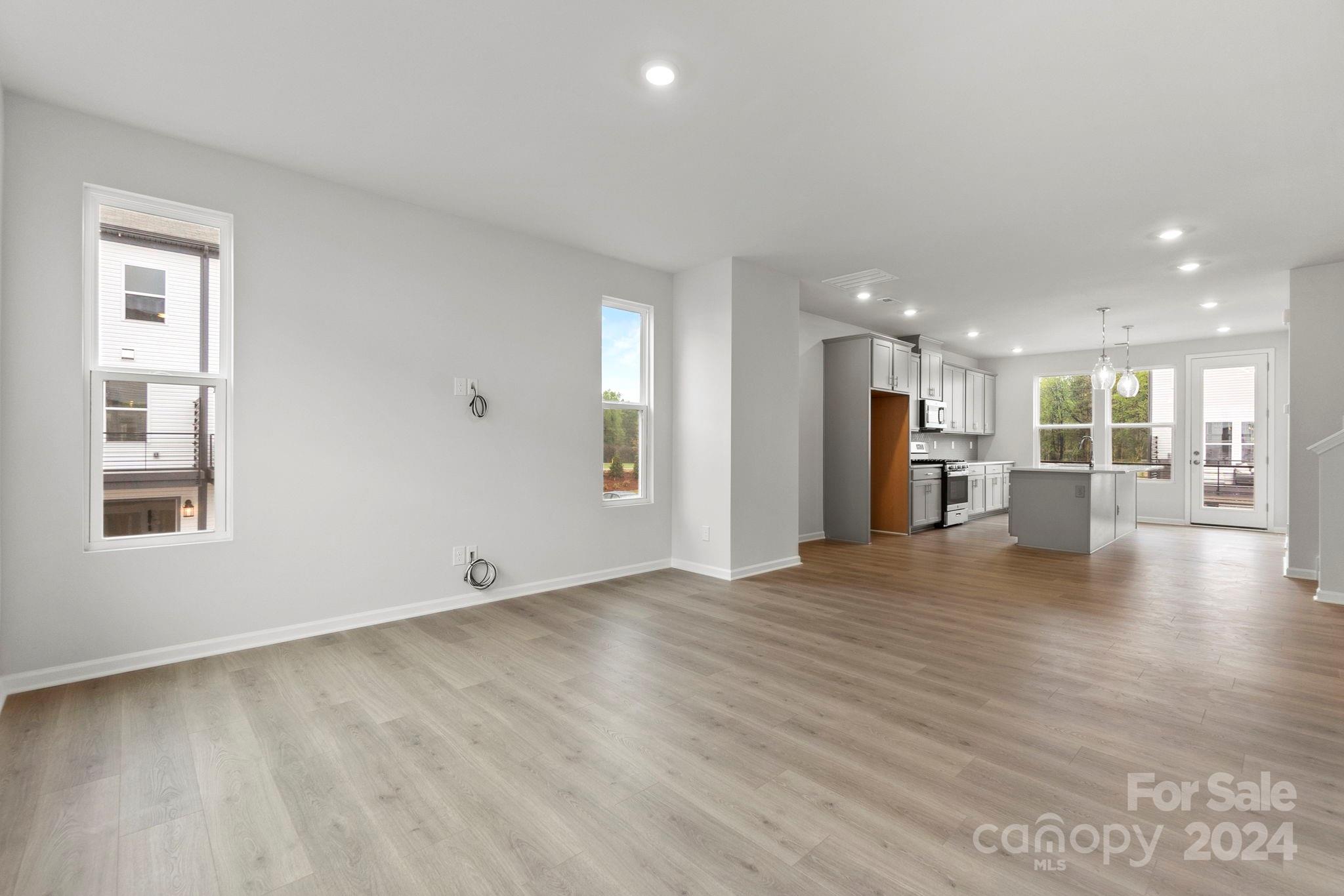 1702 Blanche Street Albemarle, NC 28001 - Photo 24 of 29 a view of an empty room with a window and kitchen view