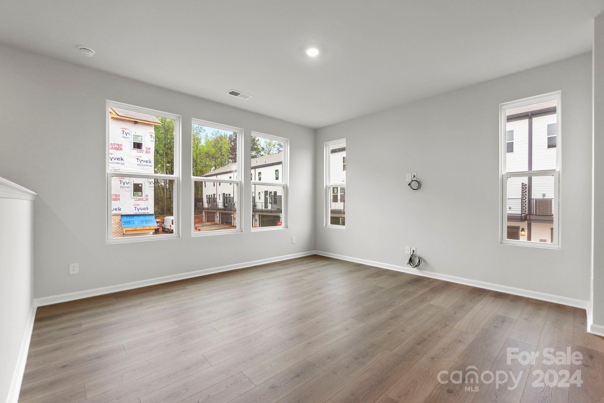 1702 Blanche Street Albemarle, NC 28001 - Photo 9 of 29 an empty room with wooden floor and windows