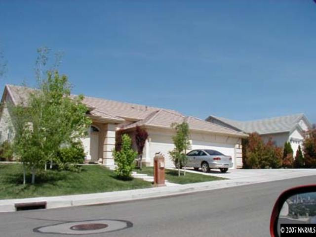 a couple of cars parked in front of a house