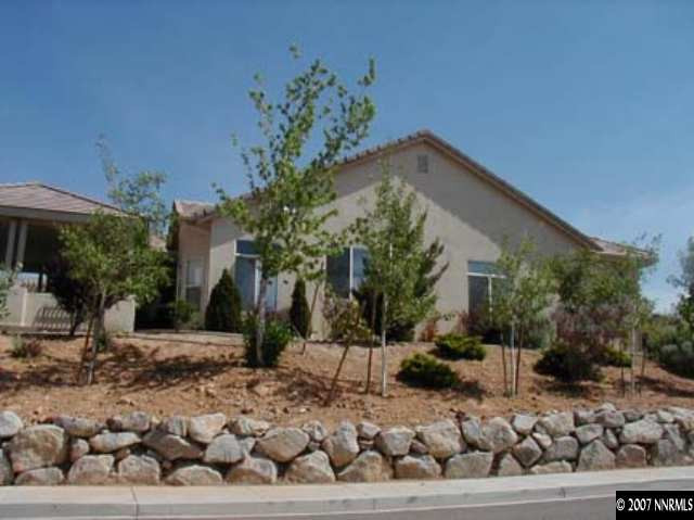 1134 University Ridge Drive Reno, NV 89512 - Photo 3 of 9 a front view of a house with a yard