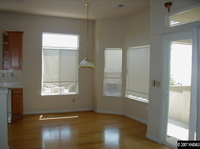 1134 University Ridge Drive Reno, NV 89512 - Photo 7 of 9 a view of an empty room with wooden floor and a window