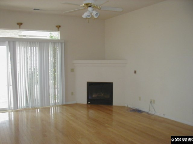 1134 University Ridge Drive Reno, NV 89512 - Photo 8 of 9 a view of an empty room with a fireplace and a window
