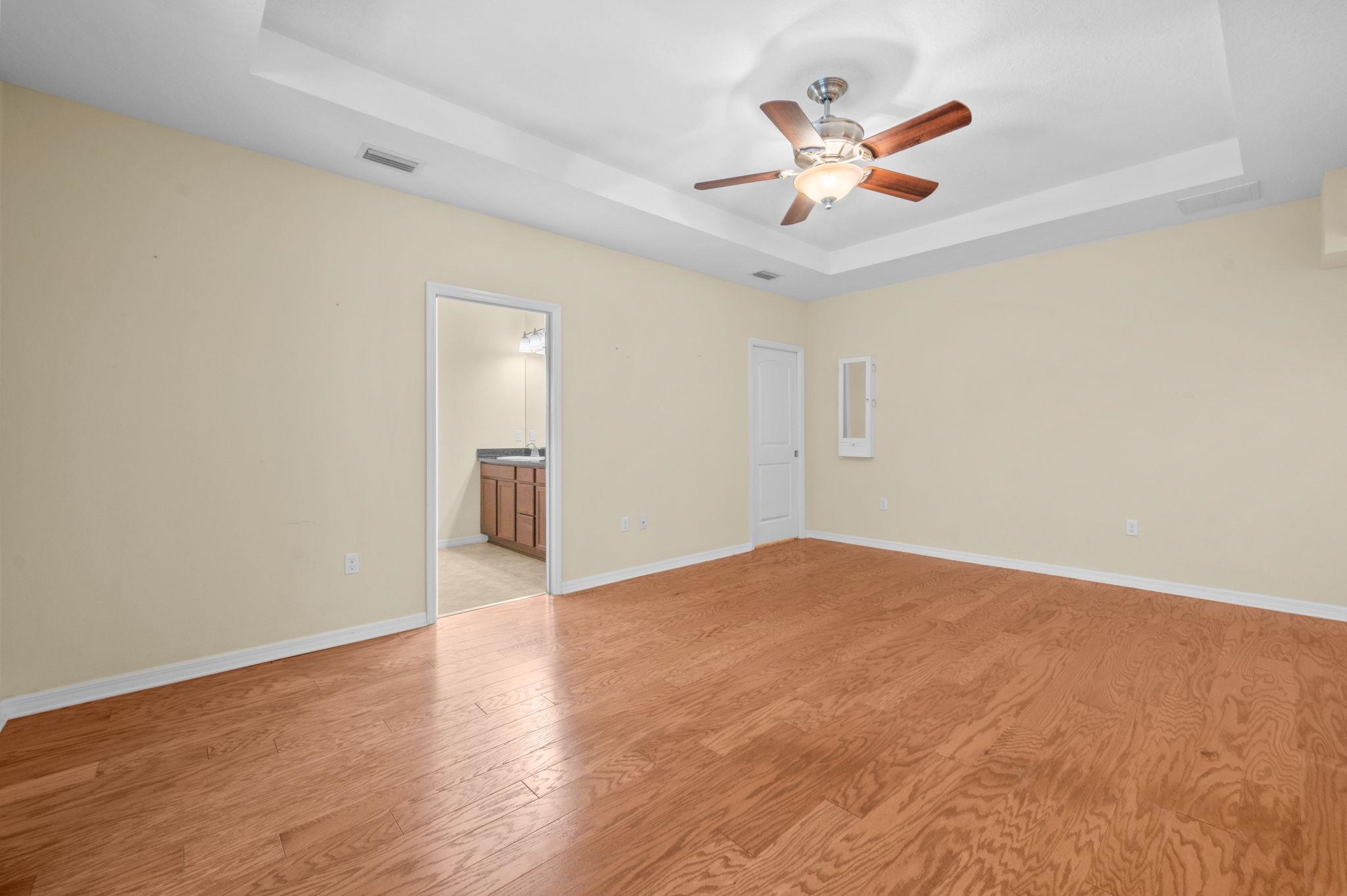 1184 Overdale Road St. Augustine, FL 32080 - Photo 10 of 75 Primary Bedroom with a tray ceiling, ceiling fan, and light wood finished floors