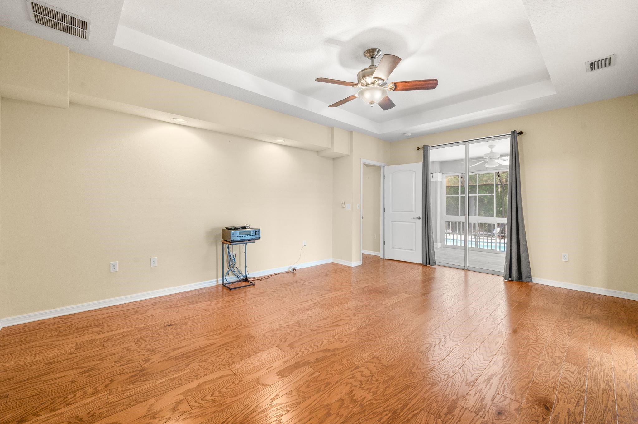 1184 Overdale Road St. Augustine, FL 32080 - Photo 11 of 75 Primary Bedroom with a raised ceiling, a ceiling fan, and light wood-style flooring