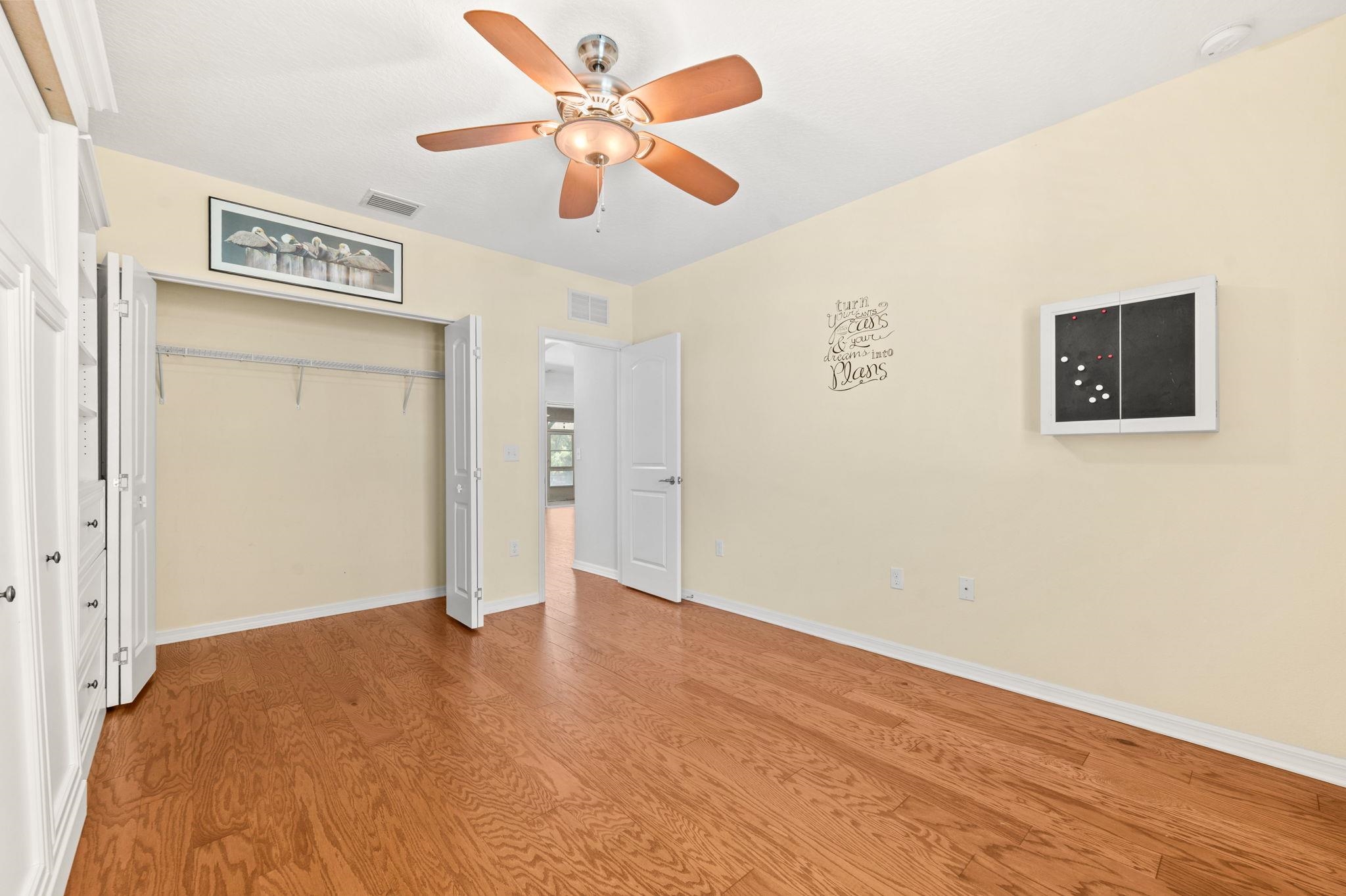 1184 Overdale Road St. Augustine, FL 32080 - Photo 16 of 75 Unfurnished bedroom with a ceiling fan, a closet, and wood finished floors