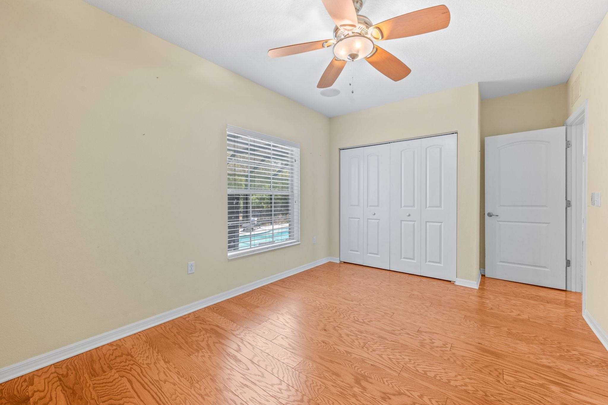 1184 Overdale Road St. Augustine, FL 32080 - Photo 19 of 75 Unfurnished bedroom featuring ceiling fan, light wood-style flooring, and a closet