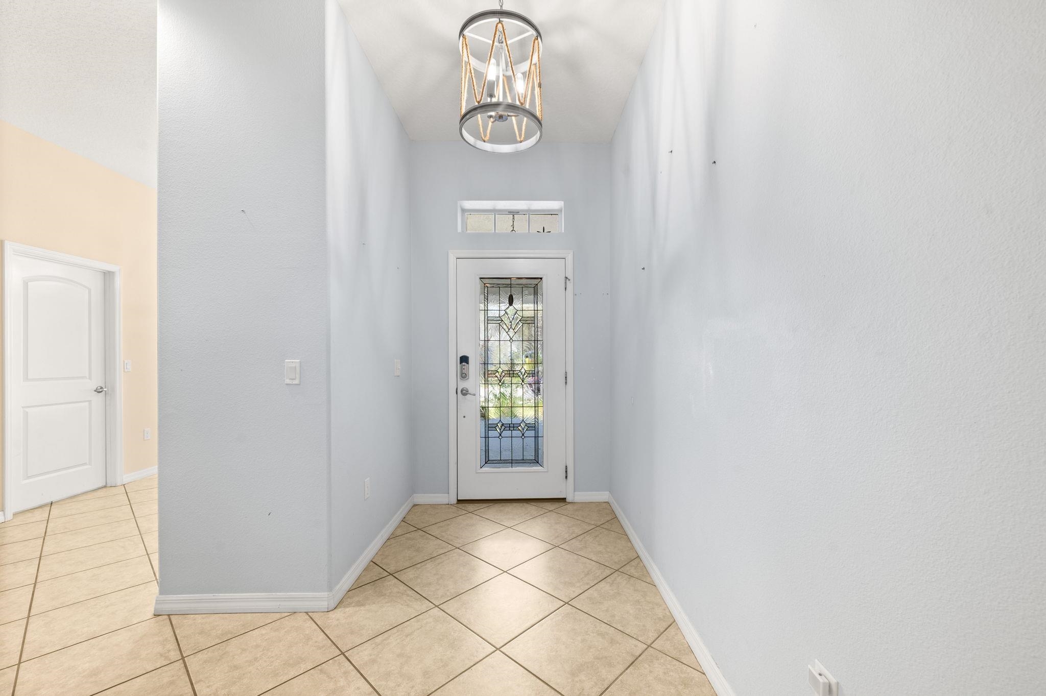 1184 Overdale Road St. Augustine, FL 32080 - Photo 4 of 75 Entrance foyer featuring a chandelier and light tile patterned flooring