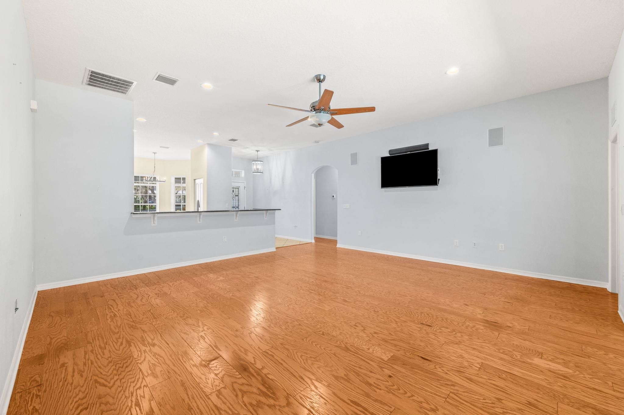 1184 Overdale Road St. Augustine, FL 32080 - Photo 48 of 75 Unfurnished living room featuring arched walkways, a ceiling fan, light wood finished floors, and recessed lighting