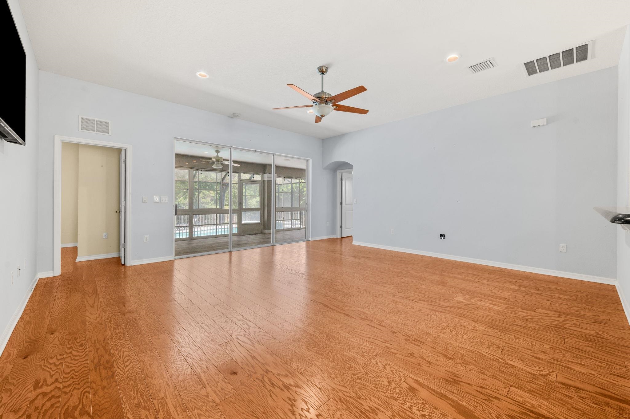 1184 Overdale Road St. Augustine, FL 32080 - Photo 49 of 75 Unfurnished living room with arched walkways, a ceiling fan, light wood-style flooring, and recessed lighting