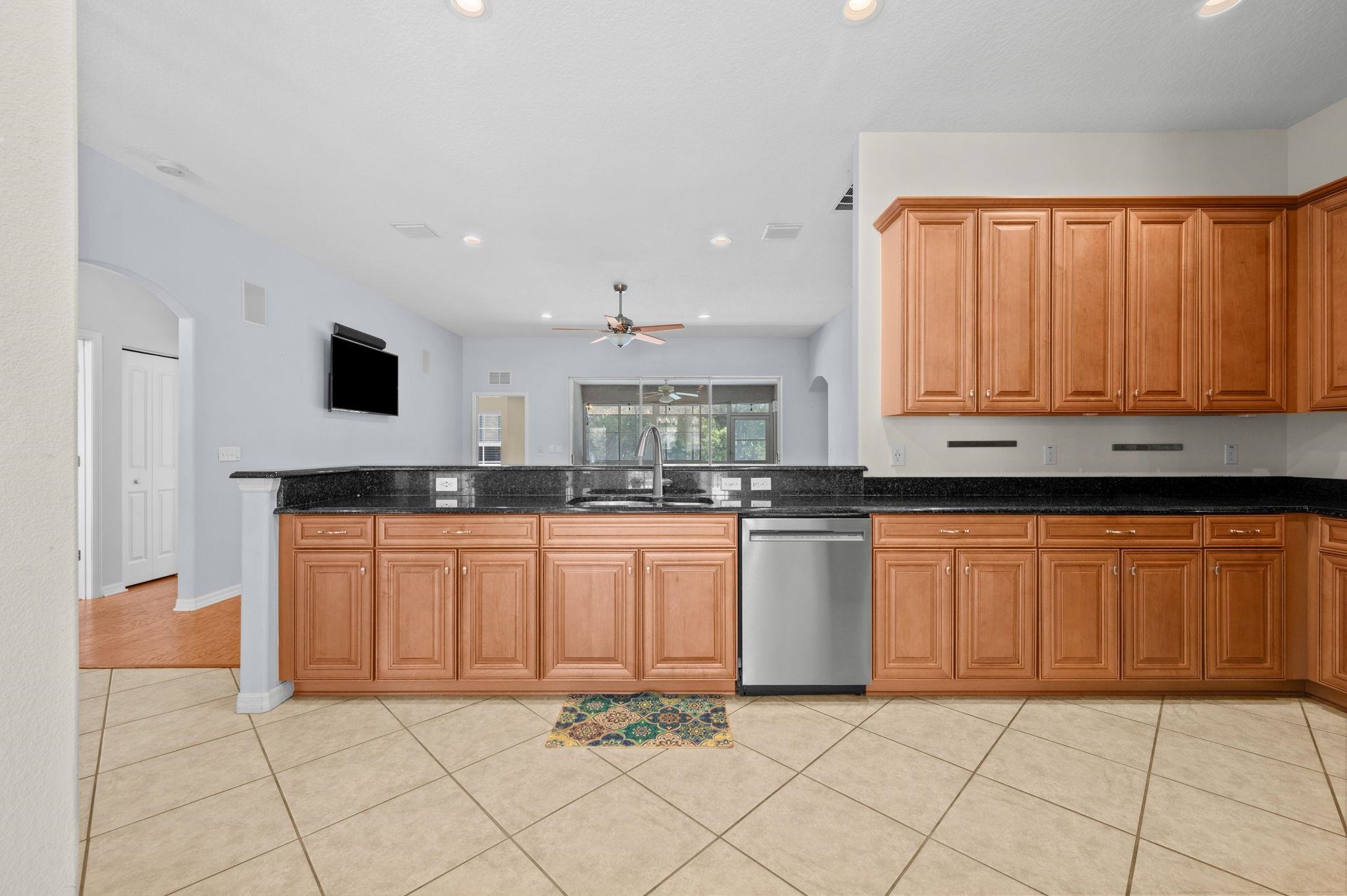 1184 Overdale Road St. Augustine, FL 32080 - Photo 50 of 75 Kitchen featuring arched walkways, light tile patterned flooring, dark stone counters, and recessed lighting