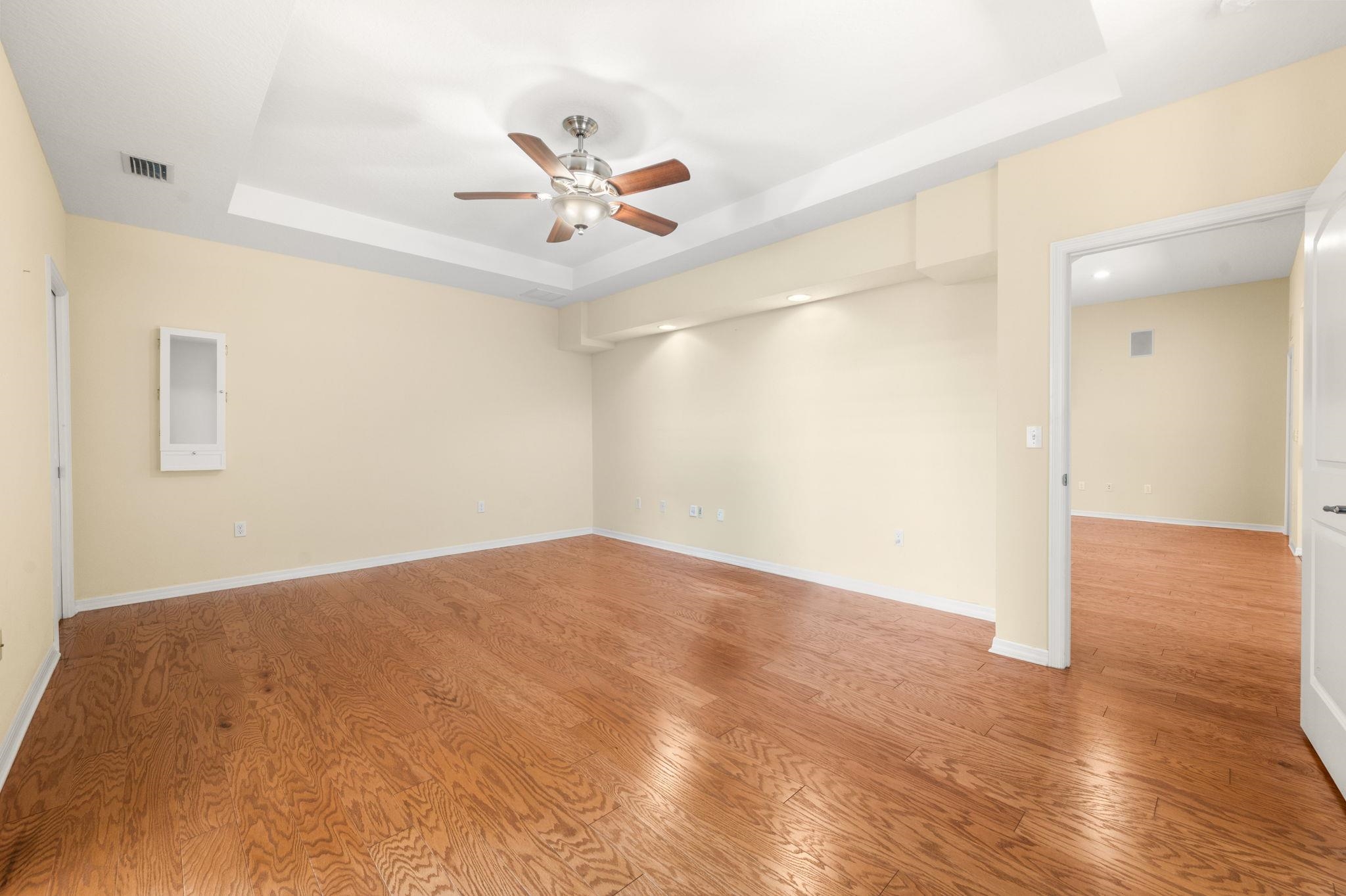 1184 Overdale Road St. Augustine, FL 32080 - Photo 51 of 75 Unfurnished room with ceiling fan, a raised ceiling, and light wood-style floors