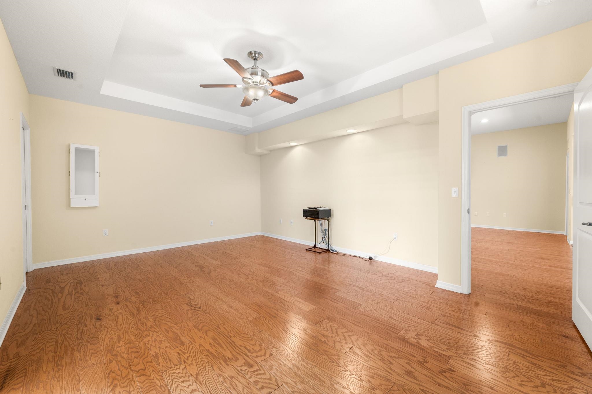 1184 Overdale Road St. Augustine, FL 32080 - Photo 52 of 75 Spare room featuring a ceiling fan, a tray ceiling, and light wood-style flooring